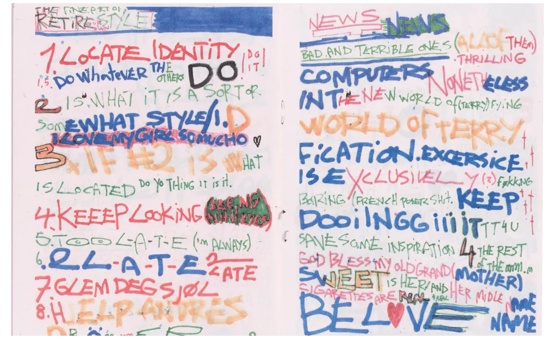 Open spread of a zine filled with colorful handwritten crayon text in red, blue, green and orange